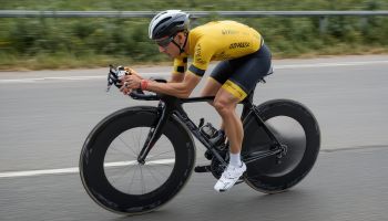 Professional cyclist in aerodynamic position on road bike